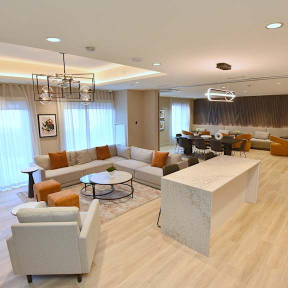 a modern living room with a large grey sofa and a white coffee table at roxy apartments, hamilton