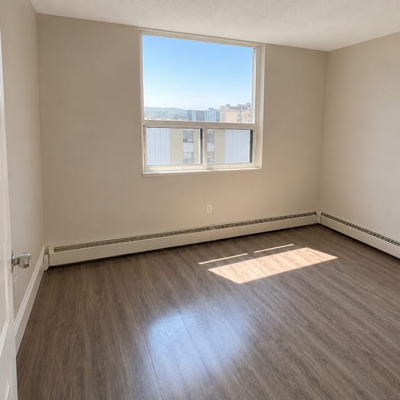 empty room with a window overlooking the city.