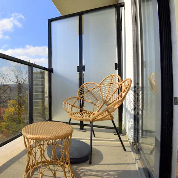 a balcony with a chair and table at roxy apartments, hamilton, on, l8h 0b7