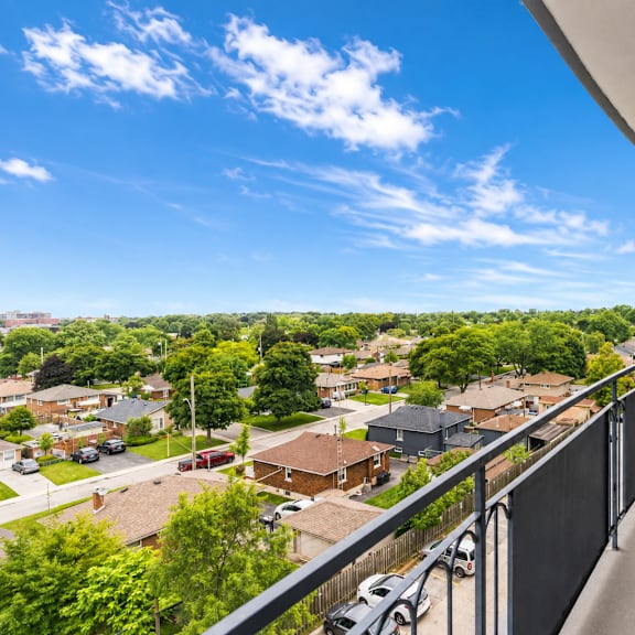 a balcony overlooks a residential neighborhood.