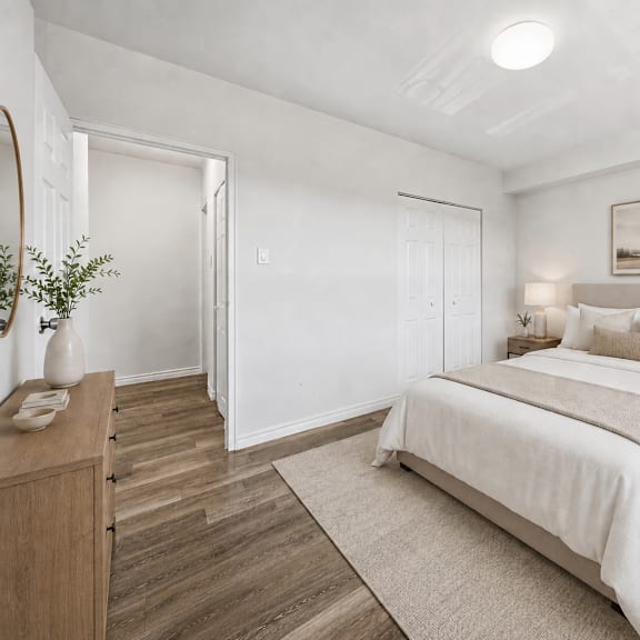 a bedroom with a large bed and a wooden dresser.