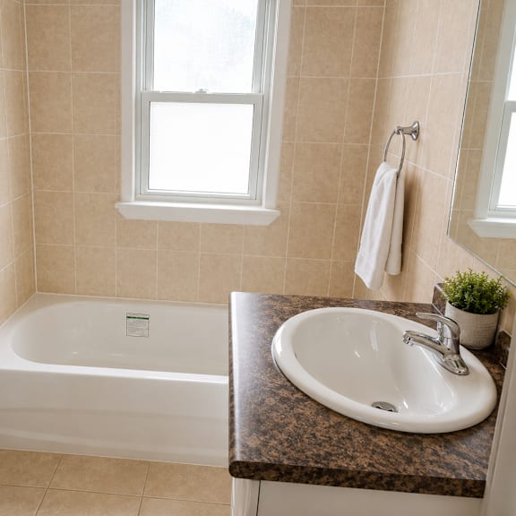 a white toilet sits next to a white bathtub in a bathroom.