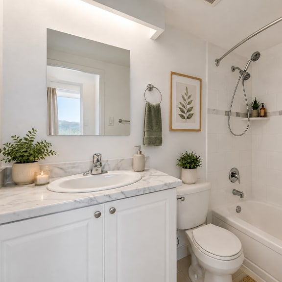 a white bathroom with a sink, toilet, and bathtub.