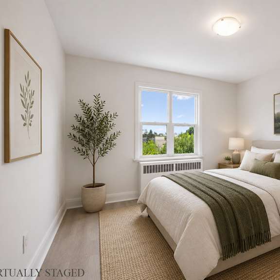 a bedroom with a large bed and a window.