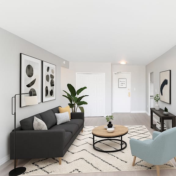 a living room with a black couch, a coffee table, and a blue chair.