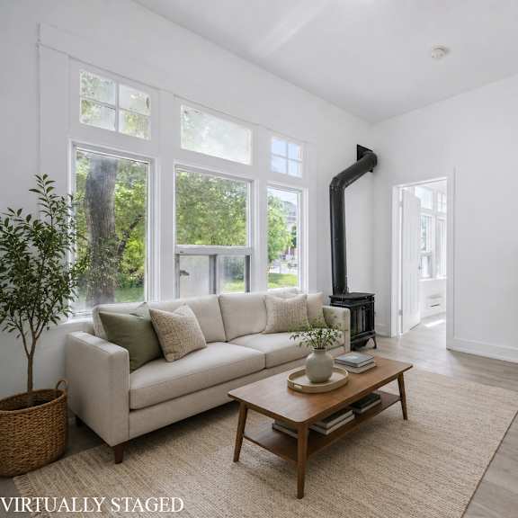 a living room with a white couch and a wooden coffee table.