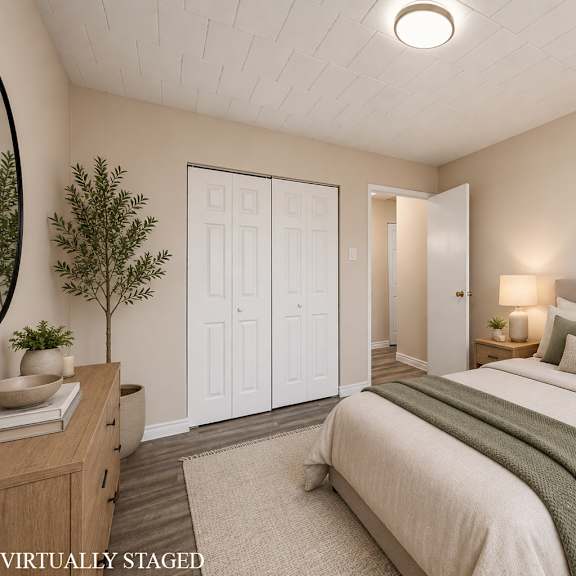 a bedroom with a bed, nightstands, and a painting on the wall.