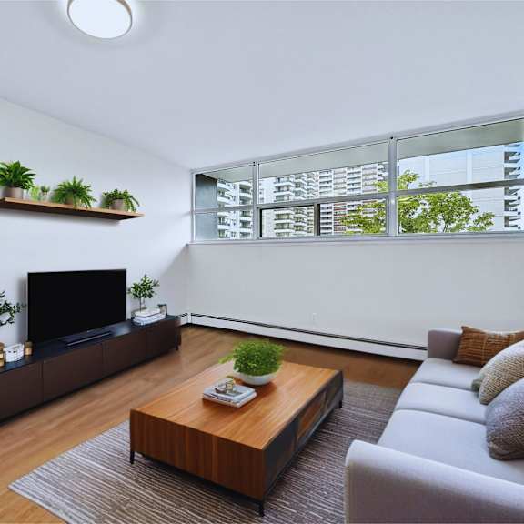 a modern living room with a flat screen tv, a wooden coffee table, and a grey sofa.