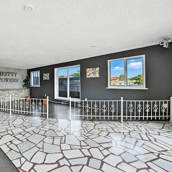 a room with a tiled floor and a sign that says "butty towers".
