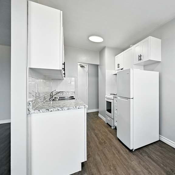 a kitchen with white appliances and cabinets.