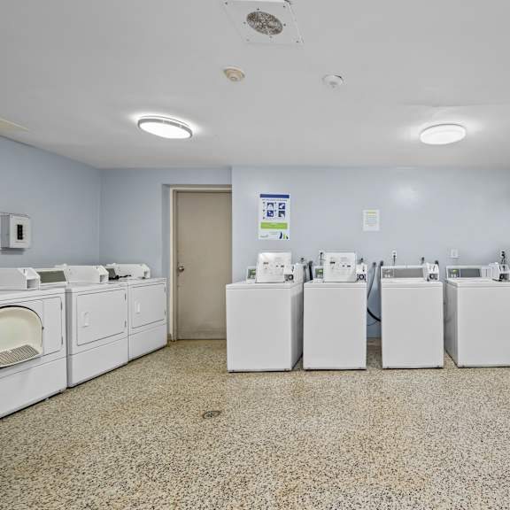 a laundry room with washers and dryers.