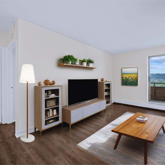 a living room with a wooden floor and a large window.