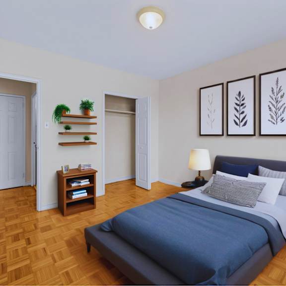 a bedroom with a bed, nightstand, and a plant on a shelf.