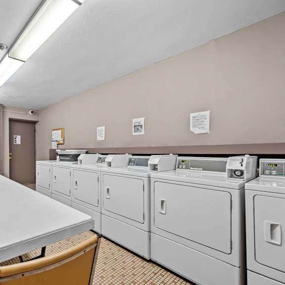 a laundry room with washers and dryers.