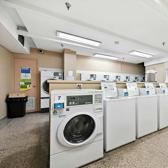 a row of washing machines in a public laundromat.