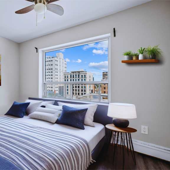 a bedroom with a large bed and a painting on the wall.