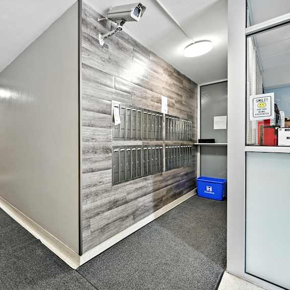 a room with a grey floor and a grey wall with a wood panel design.