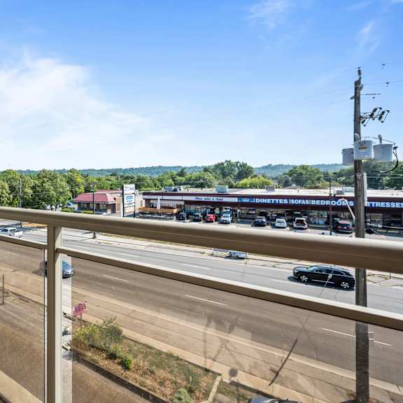 a view from a balcony overlooking a busy highway.