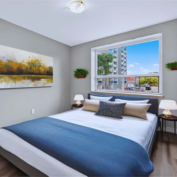 a bedroom with a large bed and a painting on the wall.