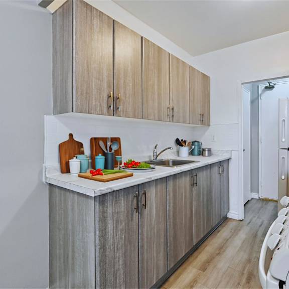 a kitchen with wooden cabinets and a white stove top oven.