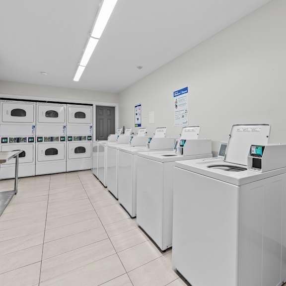 a row of washing machines in a laundromat.
