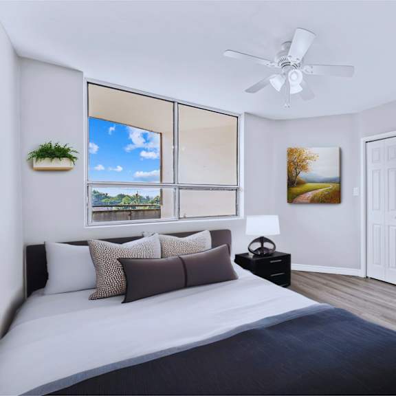 a bedroom with a large bed and a ceiling fan.
