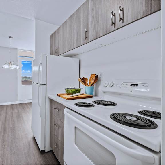 a modern kitchen with white appliances and wooden cabinets.