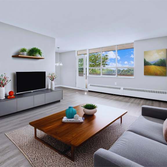 a modern living room with a grey sofa, a wooden coffee table, and a flat-screen tv.