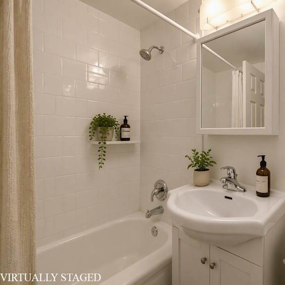 a bathroom with a white sink, toilet, and tub.