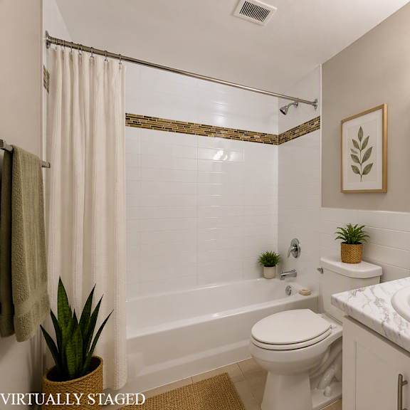 a bathroom with a toilet, sink, and mirror.