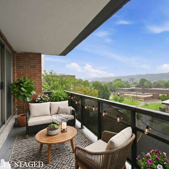 a balcony with a table and chairs overlooking a town.