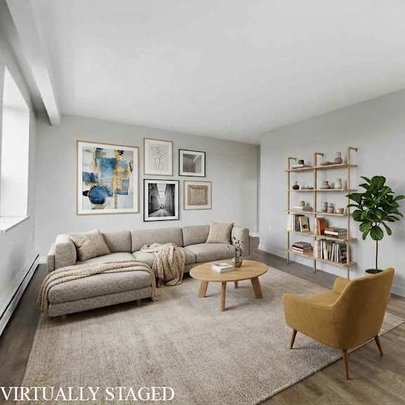 a living room with a couch, a chair, a coffee table, and a bookshelf.