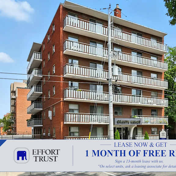 a large brick building with a sign that says "effort trust 1 month of free rent".