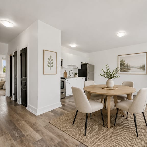 a dining room with a round table and chairs.