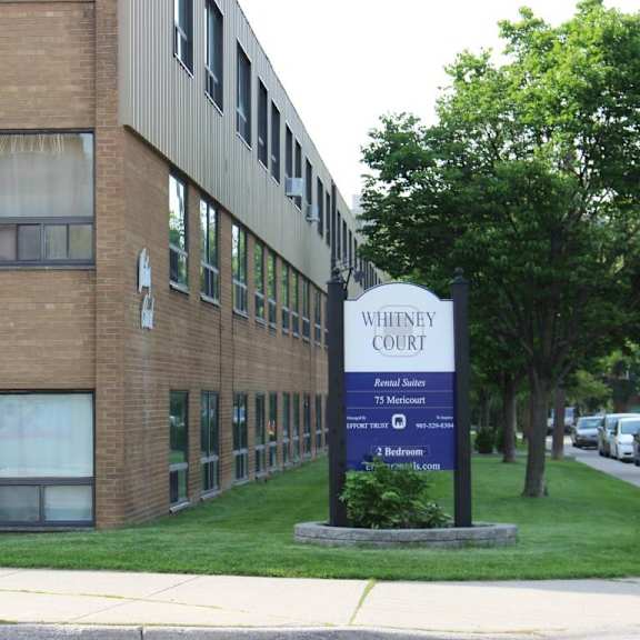 a sign in front of a building that says whitemey court.