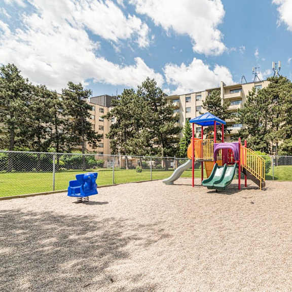 a playground with a slide, swings, and a sandbox.