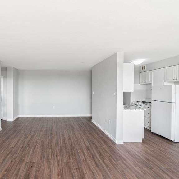 a room with wooden floors and white walls.