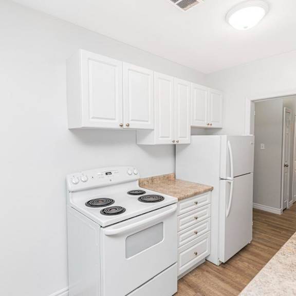 a kitchen with white appliances and cabinets.