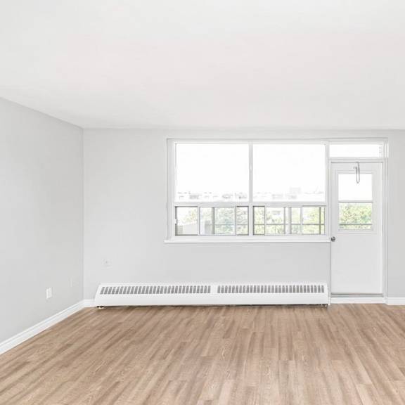a room with a white door and a window with blinds.