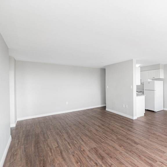 a room with wooden flooring and white walls.