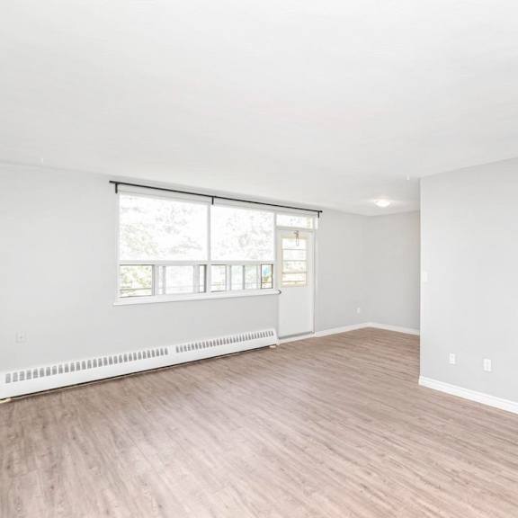 a room with a window and a door leading to another room.