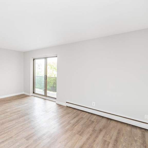 a room with wooden flooring and a window.