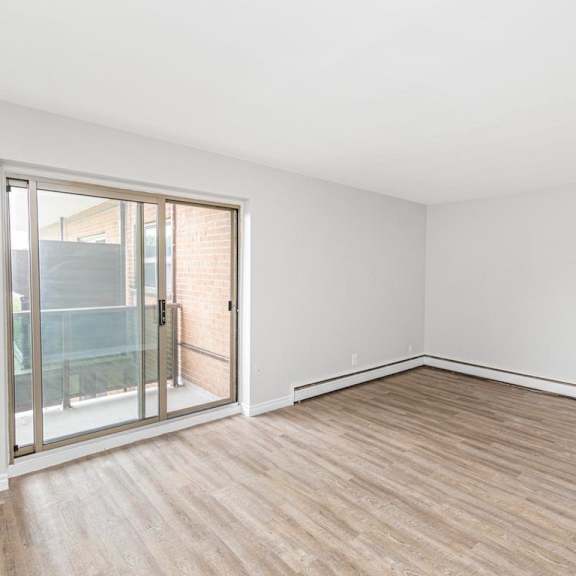 a room with a sliding glass door leading to a balcony.