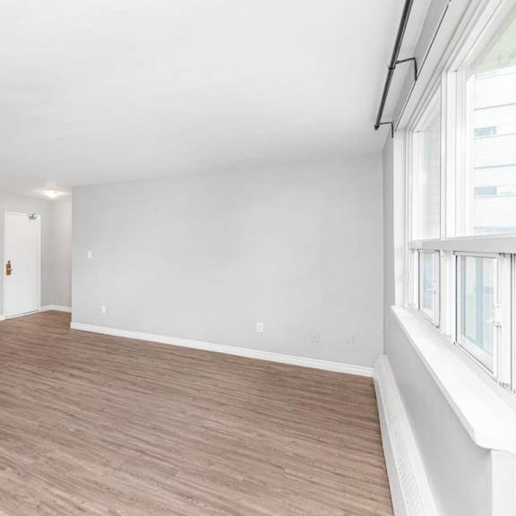 a room with wooden flooring and white walls.