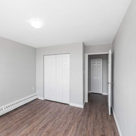 a room with a white wall and a white door.