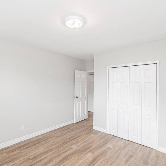 a room with a white door and a white wall.