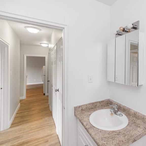 a bathroom with a sink and mirror.