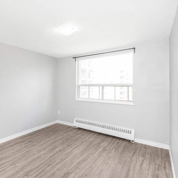 a room with a window and a radiator on the floor.