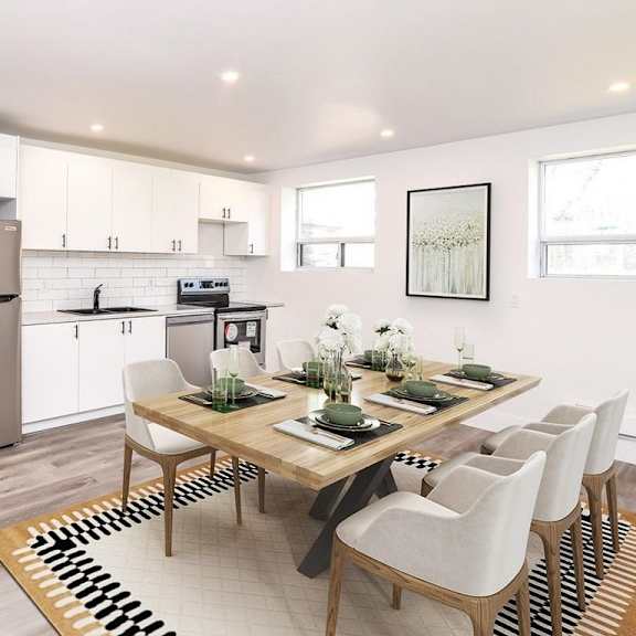 a modern kitchen with a dining table set for six.