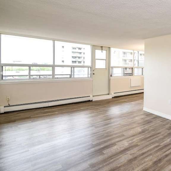 a room with wooden floors and white walls.